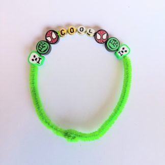 A green bracelet made out of a pipe cleaner and beads.